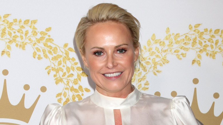 Closeup of Josie Bissett smiling on step-and-repeat